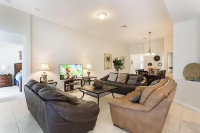 a living room with two leather couches and a table at bsv_villa7747 in Orlando
