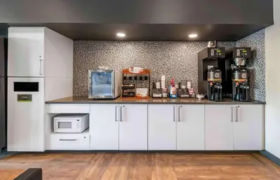 a kitchen with white cabinets and a microwave at Extended Stay America Premier Suites - Orlando - Sanford in Sanford