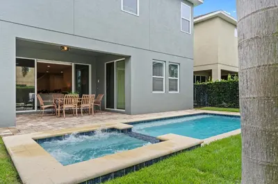 a swimming pool in the backyard of a house at Encore Resort 6 Bedroom Home with Pool 2301 in Orlando