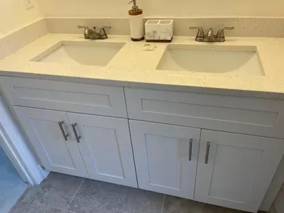 a bathroom with two sinks and white cabinets at ELEGANT & LUXURIOUS FAMILY APARTMENT close to DISNEY WORLD in Kissimmee