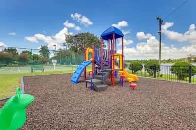 a playground with a slide in a park at Steps to Pool Winter Garden House with Lanai! in Orlando