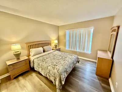 a bedroom with a bed and a window at Grand Holiday 3BR Palms Condo near Disney Parks in Kissimmee