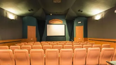 an empty auditorium with a screen in a theatre at Immaculate 4 bedrooms 3 bathroom in Windsor Palms villa in Kissimmee
