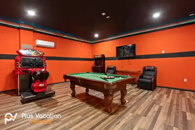 a pool table in a room with orange walls at 7541 Huge 8BD Home - POOLSpa - GameMovie room in Orlando