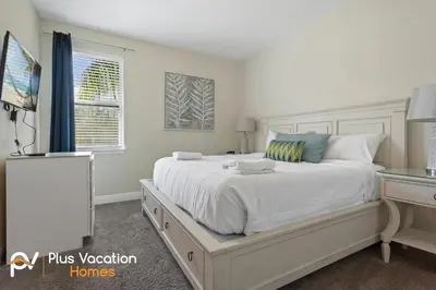 a bedroom with a large white bed and a desk at 7541 Huge 8BD Home - POOLSpa - GameMovie room in Orlando