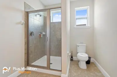 a bathroom with a shower and a toilet at 7541 Huge 8BD Home - POOLSpa - GameMovie room in Orlando