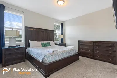 a bedroom with a bed and dressers and a window at 7541 Huge 8BD Home - POOLSpa - GameMovie room in Orlando