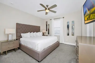 a bedroom with a bed and a ceiling fan at Gleaming Home With Private Pool, Theater Room And Water Park Access Near Disney At Encore Resorts Reunion - 209Sf in Kissimmee
