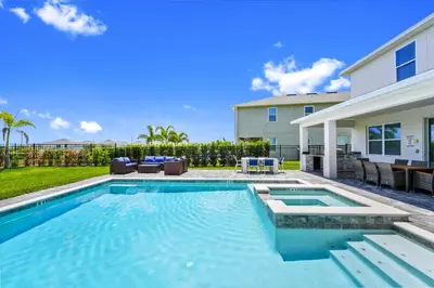 a swimming pool in the backyard of a house at Gleaming Home With Private Pool, Theater Room And Water Park Access Near Disney At Encore Resorts Reunion - 209Sf in Kissimmee
