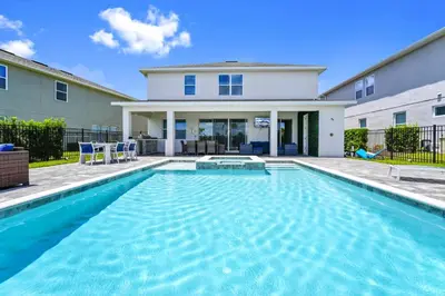 a swimming pool in front of a house at Gleaming Home With Private Pool, Theater Room And Water Park Access Near Disney At Encore Resorts Reunion - 209Sf in Kissimmee