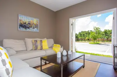 a living room with a couch and a table at 5370 INCREDIBLE 8 MINS TO DISNEY LUCAYA VILLAGE RESORT in Kissimmee