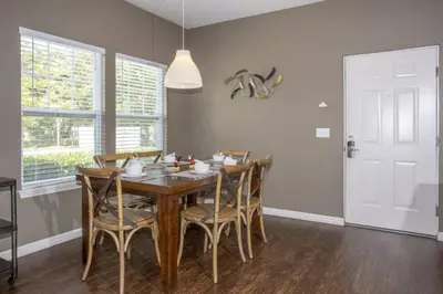 a dining room with a wooden table and chairs at 5370 INCREDIBLE 8 MINS TO DISNEY LUCAYA VILLAGE RESORT in Kissimmee