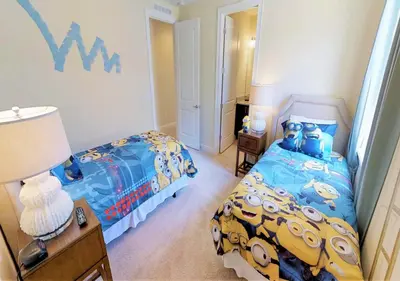 a bedroom with a bed with a mickey mouse bedspread at 7613-IBRAHIM · 7613 Paradise at Encore wiith Private pool in Orlando