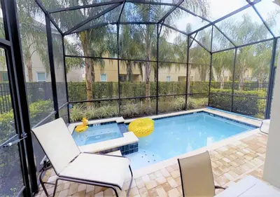a swimming pool in a greenhouse with a hot tub at 7613-IBRAHIM · 7613 Paradise at Encore wiith Private pool in Orlando