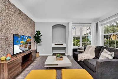 a living room with a couch and a tv at 2 Bedroom Vacation Condo 2016 in Kissimmee
