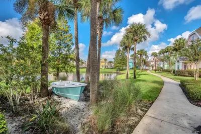 a boat on the side of a walkway with palm trees at 2 Bedroom Vacation Condo 2016 in Kissimmee
