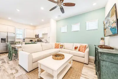 a living room with a couch and a table at Relaxing Cottage Near Disney With Margaritaville Resort & Island H20 Waterpark Access - 2964Sr in Orlando