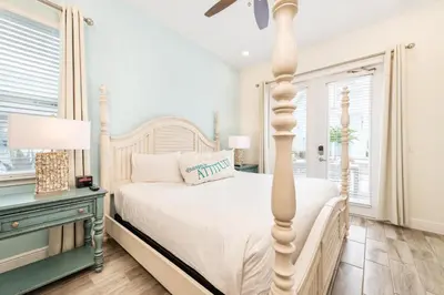 a white bedroom with a white bed and a table at Relaxing Cottage Near Disney With Margaritaville Resort & Island H20 Waterpark Access - 2964Sr in Orlando