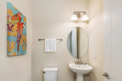 a bathroom with a sink and a mirror at Sunny Yellow Cottage Near Disney With Margaritaville Resort Access & Island H20 Waterpark - 3075Kl in Orlando