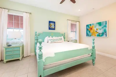 a bedroom with a green bed and a window at Sunny Yellow Cottage Near Disney With Margaritaville Resort Access & Island H20 Waterpark - 3075Kl in Orlando