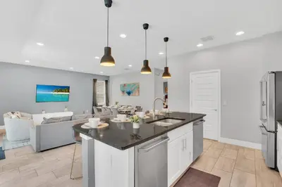 a kitchen and living room with a kitchen island and a couch at 650 Lasso Drive in Orlando