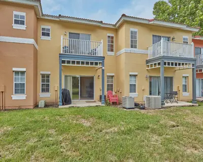 a large house with a yard in front of it at Spring retreat near Disney, Perfect for families in Kissimmee