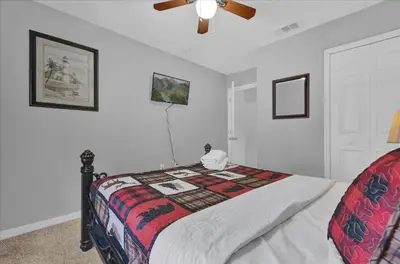a bedroom with a bed and a ceiling fan at Spring retreat near Disney, Perfect for families in Kissimmee