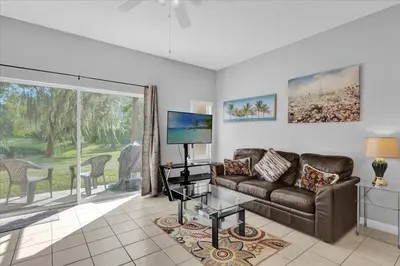 a living room with a couch and a tv at Spring retreat near Disney, Perfect for families in Kissimmee