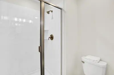 a bathroom with a shower and a toilet at Family Resort - 4BR Home Near Disney - Private Pool, BBQ! in Kissimmee