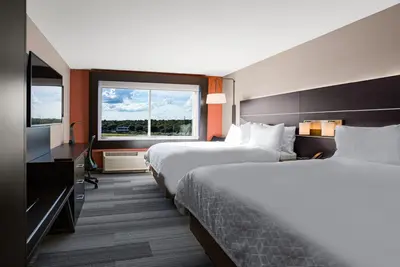 a hotel room with two beds and a television at Holiday Inn Express & Suites Sanford - Lake Mary by IHG in Sanford