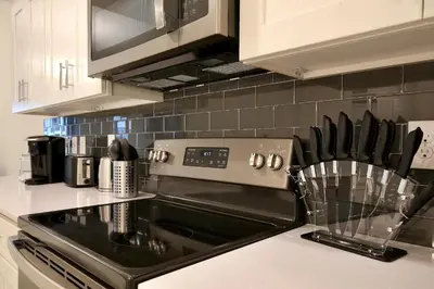 a kitchen with a stove top oven in a kitchen at High end apartment in luxurious Storey Lake community Next to Disney! in Kissimmee
