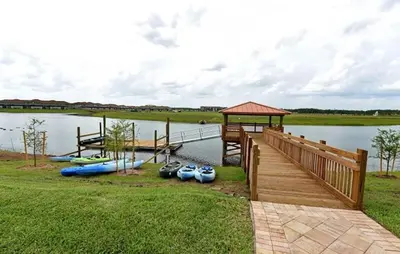 a dock with a bunch of boats on the water at High end apartment in luxurious Storey Lake community Next to Disney! in Kissimmee