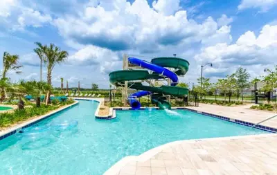 a water slide in a pool at a resort at High end apartment in luxurious Storey Lake community Next to Disney! in Kissimmee