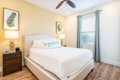 a bedroom with a white bed and a window at Lively Cottage Near Disney With Margaritaville Resort & Island H20 Waterpark Access - 2998Sr in Orlando