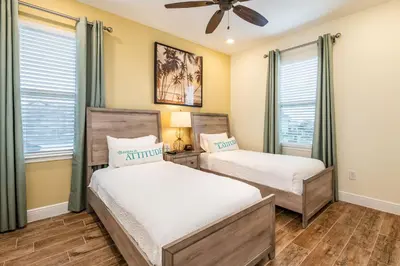 a bedroom with two beds and a ceiling fan at Lively Cottage Near Disney With Margaritaville Resort & Island H20 Waterpark Access - 2998Sr in Orlando