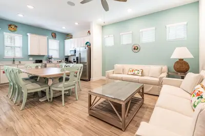 a living room with a couch and a table at Don't Worry, Beach Happy Cottage Near Disney With Private Hot Tub & Margaritaville Resort & Island H20 Waterpark Access - 3005Sp in Orlando