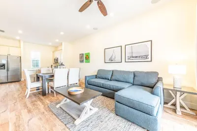 a living room with a couch and a table at Coral Bliss Cottage Near Disney With Margaritaville Resort & Island H2O Access - 8004Ls in Orlando