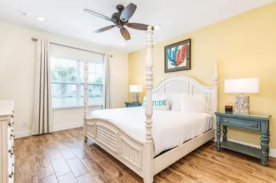 a bedroom with a white bed and a ceiling fan at Toes In The Water Cottage With Private Pool Near Disney With Margaritaville Resort & Island H2O Access - 8008Sh in Orlando