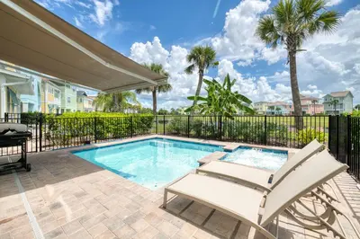 a swimming pool with a chair and a patio with a swimming poolvisorvisorvisor at Toes In The Water Cottage With Private Pool Near Disney With Margaritaville Resort & Island H2O Access - 8008Sh in Orlando