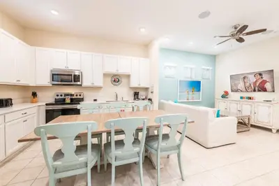 a kitchen with a table and chairs in a room at Comfy Cottage With Hot Tub Near Disney With Margaritaville Resort & Island H2O Access - 8029Sb in Orlando