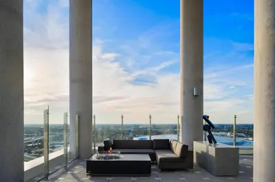 a living room with columns and a couch on a balcony at AC Hotel by Marriott Orlando Downtown in Orlando