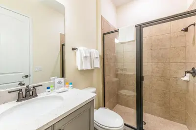 a bathroom with a shower and a toilet and a sink at Paradise Cottage Near Disney With Margaritaville Resort & Island H20 Access - 8137Su in Orlando