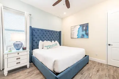 a bedroom with a blue bed and a window at Paradise Cottage Near Disney With Margaritaville Resort & Island H20 Access - 8137Su in Orlando
