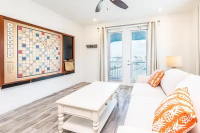 a living room with a white couch and a table at Beautiful Cottage With Private Pool Near Disney With Margaritaville Resort & Island H20 Access - 8153Su in Orlando
