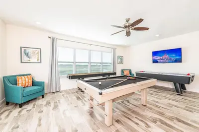 a living room with a pool table and a ceiling fan at Beautiful Cottage With Private Pool Near Disney With Margaritaville Resort & Island H20 Access - 8153Su in Orlando