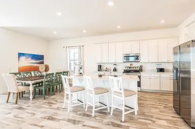 a kitchen and dining room with a table and chairs at Beautiful Cottage With Private Pool Near Disney With Margaritaville Resort & Island H20 Access - 8153Su in Orlando