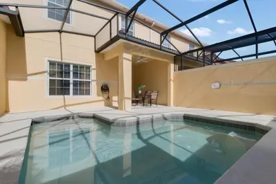 a swimming pool in the backyard of a house at Townhome w pool near Disney & Orlando Attractions in Kissimmee