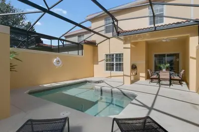 a swimming pool in the backyard of a house at Townhome w pool near Disney & Orlando Attractions in Kissimmee