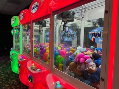 a group of arcade machines filled with stuffed animals at Townhome w pool near Disney & Orlando Attractions in Kissimmee