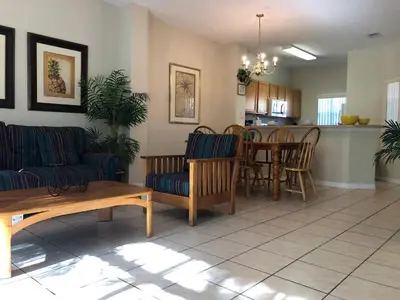 a living room with a couch and a table at Gated Emerald island resort townhome, Overlook Pool, 3 miles to Disney, rent by owner in Kissimmee